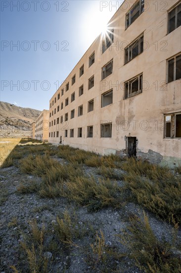 Abandoned destroyed residential building, Sun Star, old Soviet apartment block in the ghost town,
