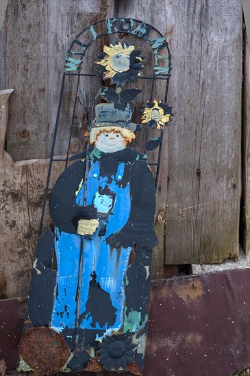 Discarded welcome sign leaning against a wooden wall, Bavaria, Germany, Europe