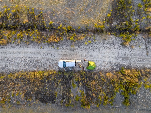 Camping with green tent and off-road vehicle Toyota Land Cruiser, top down shot, Toktogul,