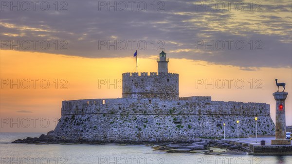 A castle by the sea with a breathtaking sunset in the background, sunrise, dawn, Fort of Saint