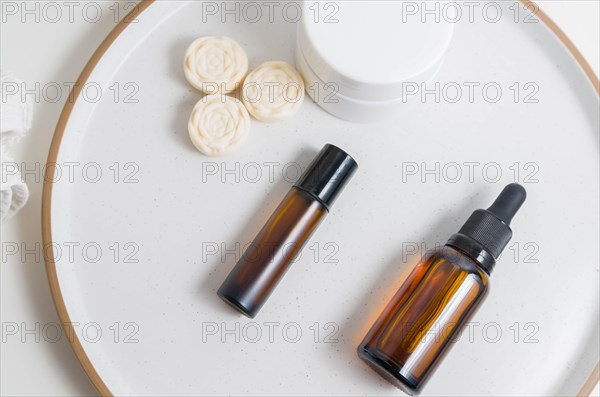 Cosmetic packaging. Set of different cosmetics on plate with decoration. Skin care concept