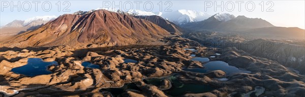 Aerial view, high mountain landscape with glacial moraines and mountain lakes, behind Pik Lenin,