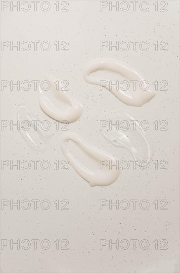 Cosmetic smears of creamy texture on a beige background