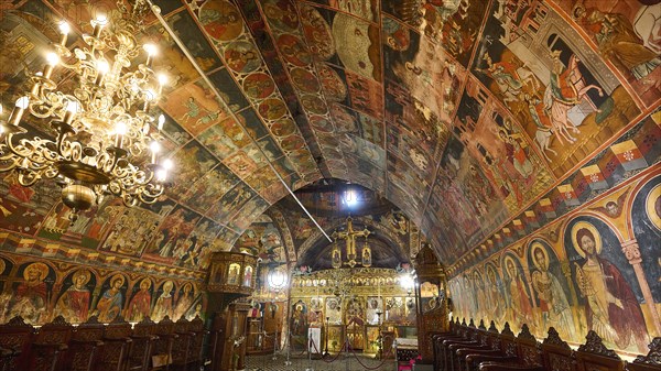 Interior view of an Orthodox church with richly decorated frescoes and an iconostasis, Panagia