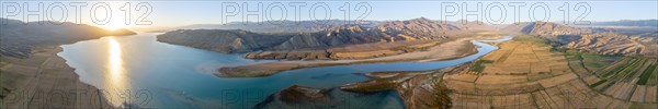 Panorama, River mouth of the Naryn River at Toktogul Reservoir at sunset, aerial view, Kyrgyzstan,