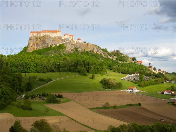 Riegersburg in the evening light, foreground farmland, Riegersburg, Styrian volcanic region,