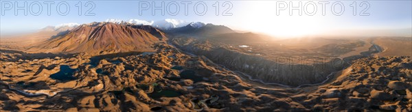 Atmospheric aerial view, high mountain landscape with glacier moraines and mountain lakes, behind