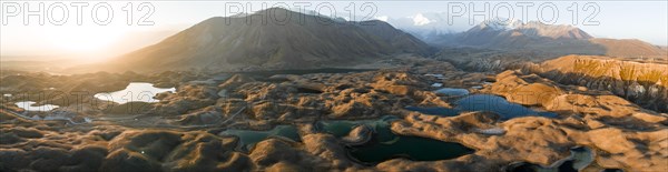 Aerial view, high mountain landscape with glacial moraines and mountain lakes, behind Pik Lenin,