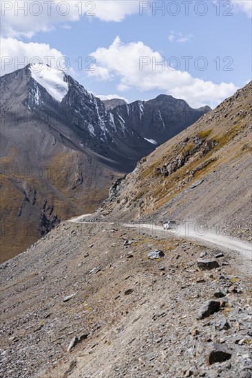 Off-road car on mountain pass, gravel road in the mountains in the Tien Shan, Engilchek Valley,