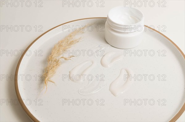 Cosmetic smears of creamy texture on a beige background