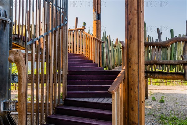 Wooden support columns and stairway going up to observation deck of tower in mountainside public