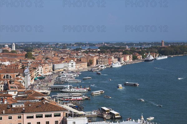 Water taxis and vaporettos along the Riva degli Schiavoni promenade plus old Renaissance