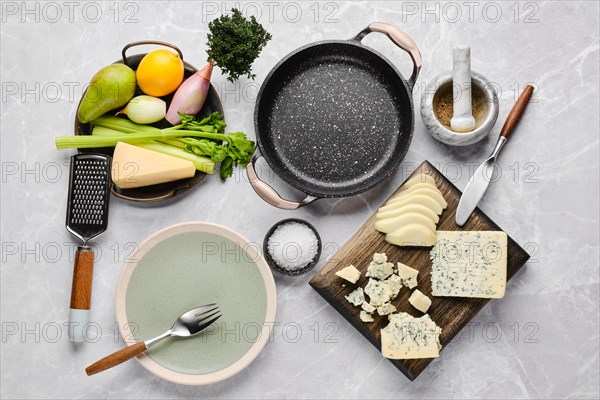 Top view of ingredients for risotto with pink rice, pear and blue cheese