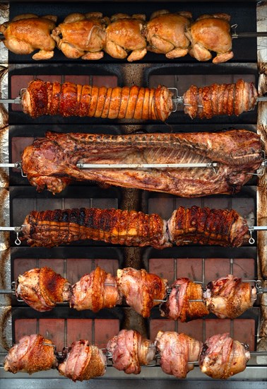 Flame wall grill with chicken possibly Turkey, ribs, pork knuckle in the marquee at the spring