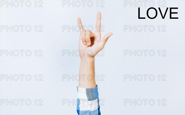 Hand gesturing LOVE in sign language. Hand of man gesturing LOVE in sign language