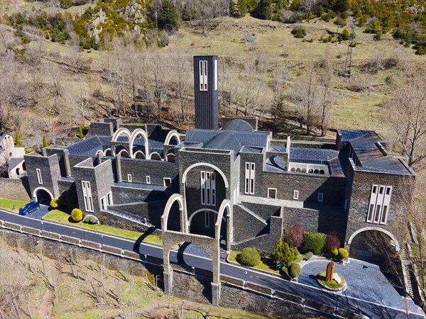 Aerial view of a historic monastery complex surrounded by greenery and Cypress trees, Santuario de