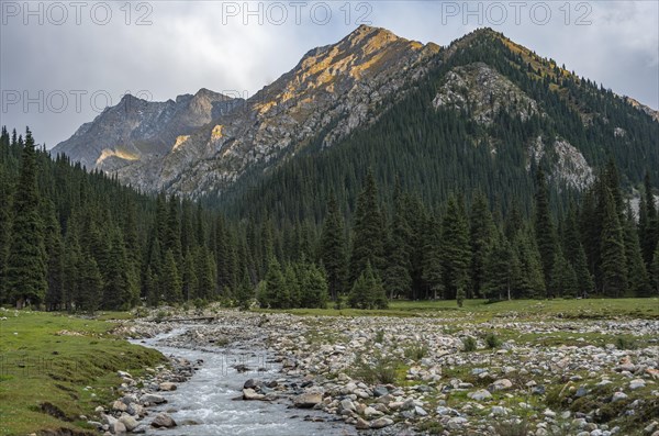 Green mountain valley with river and steep mountain peaks, Chong Kyzyl Suu Valley, Terskey Ala Too,