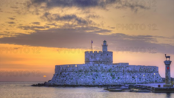 The fortress near the coast under a sky with sunset colours, sunrise, dawn, lighthouse, European