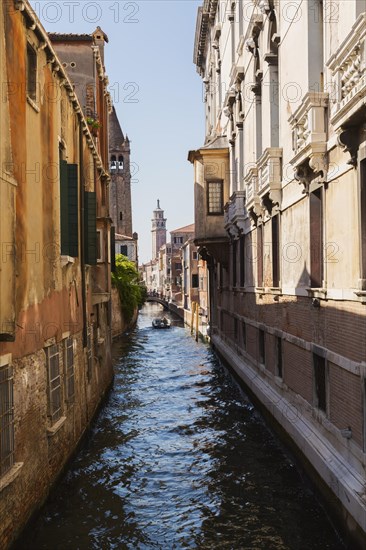 Narrow canal with Renaissance architectural style residential palace buildings, footbridge and