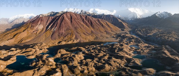 Aerial view, high mountain landscape with glacial moraines and mountain lakes, behind Pik Lenin,
