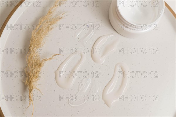 Cosmetic smears of creamy texture on a beige background
