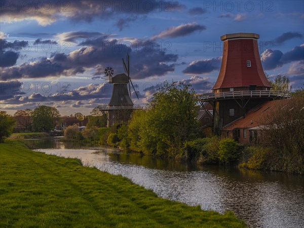 The twin mills at the old Greetsieler Sieltief at sunset, Greetsiel, Krummhoern, East Frisia, Lower