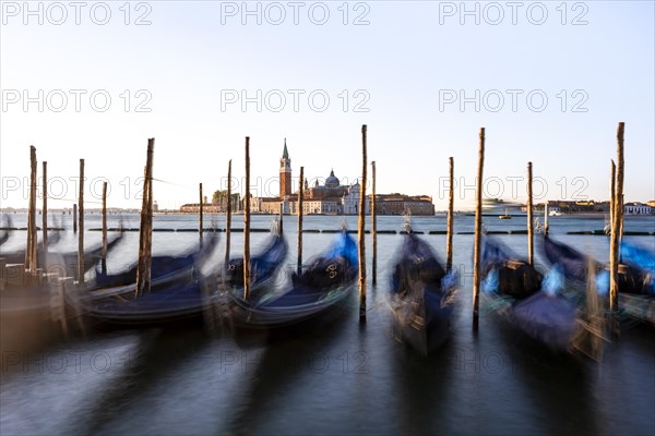 Venetian gondolas, boat dock at St Mark's Square, church of San Giorgio Maggiore in the background,