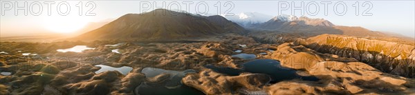 Aerial view, high mountain landscape with glacial moraines and mountain lakes, behind Pik Lenin,