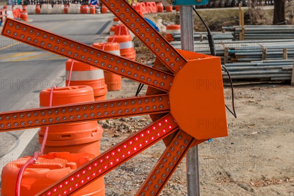 Fan shaped LED construction warning light on rural roadside next to construction site in South