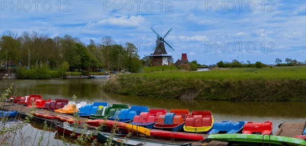 The Greetsiel twin mills, in front boats in the new Greetsieler Sieltief, panoramic photo,