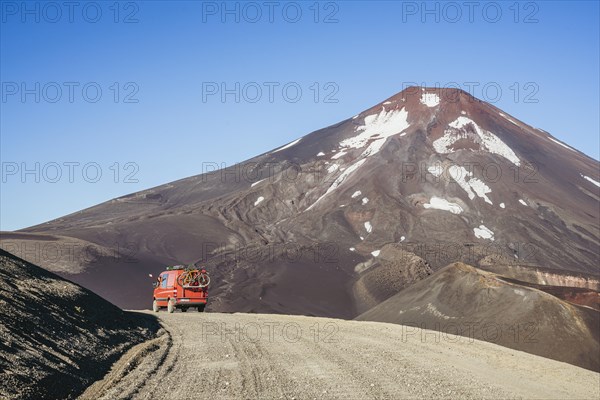 Campervan in front of the Lonquimay volcano, Lonquimay volcano, Malalcahuello National Reserve,