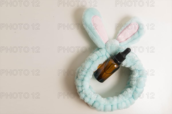 Cosmetic packaging. Set of different cosmetics on plate with decoration and bunny headband