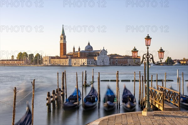 Venetian gondolas, boat dock at St Mark's Square, church of San Giorgio Maggiore in the background,