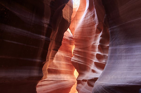 Rock arch in the canyon illuminated from above creates a soft play of light and shadow, Upper