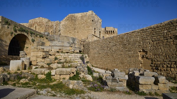 Ancient ruins with an arch and a clear view of the blue sky, St John's Fortress, Lindos, Rhodes,