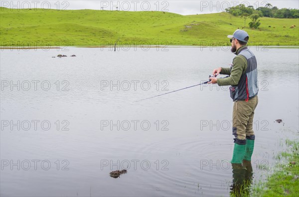 Black bass fisherman fishing with flyfishing, Cambara do sul, Rio Grande do sul, Brazil, South