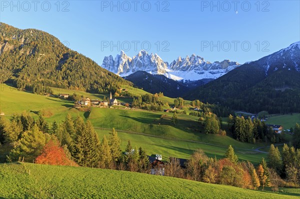 Idyllic landscape with village surrounded by meadows and a mountain panorama, Italy, Trentino-Alto