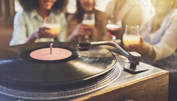 Friends enjoy drinks vinyl record playing together in cozy setting at sunset, bokeh effect ai