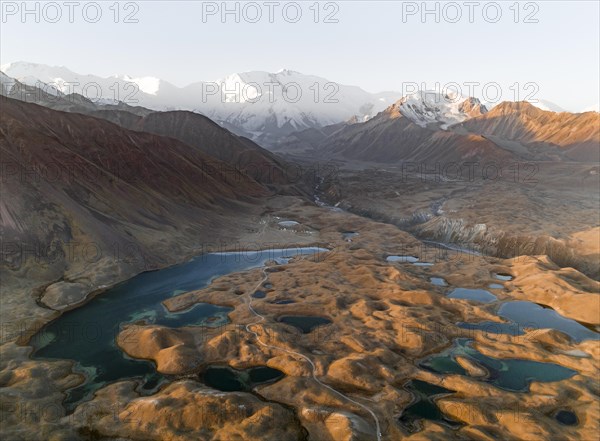 Aerial view, high mountain landscape with glacial moraines and mountain lakes, behind Pik Lenin,