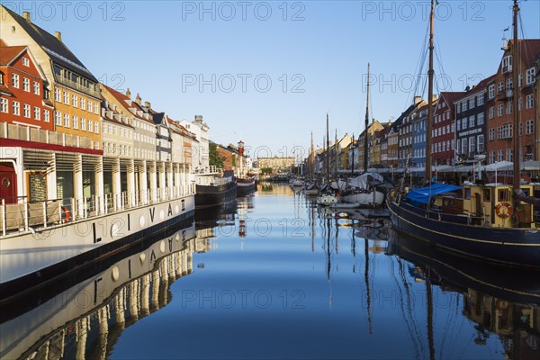 Moored Liva II restaurant boat, ships and colourful 17th century apartment buildings and houses