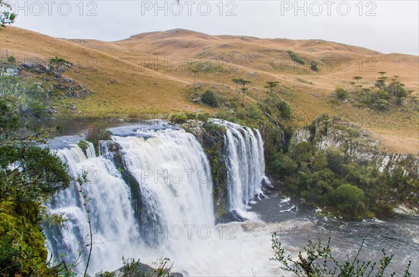 Green waterfall-river-rocks-covered with green moss-forest-waterfall. deep forest in the center of