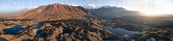 Aerial view, high mountain landscape with glacial moraines and mountain lakes, behind Pik Lenin,