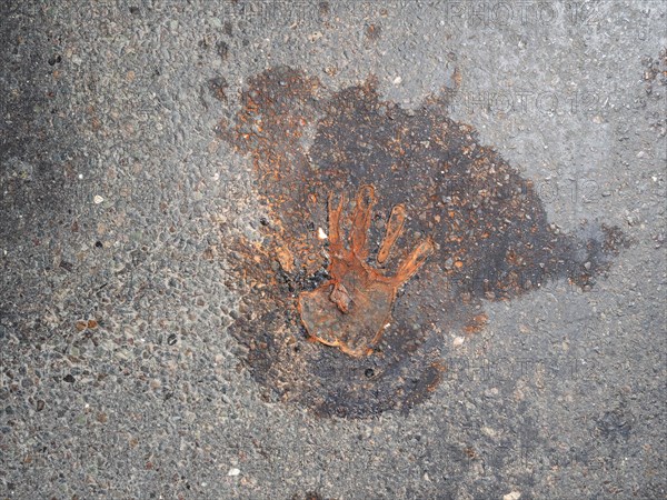 Handprint on the asphalt, after removal of a climate sticker, Leoben, Styria, Austria, Europe