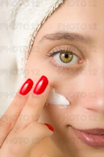 Hydration. Cream smear. Beuaty close up portrait of young woman with a healthy glowing skin is
