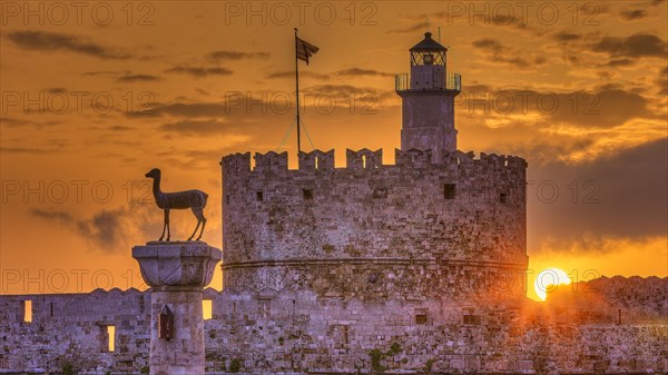 An old castle with a statue in honour of a sunrise under bright clouds, Sunrise, Dawn, Fort of