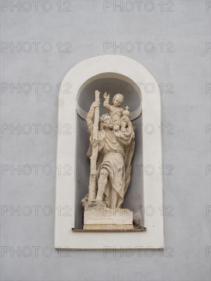 Sculpture on the church wall, St Christopher, parish church zum Heiland, Roman Catholic parish