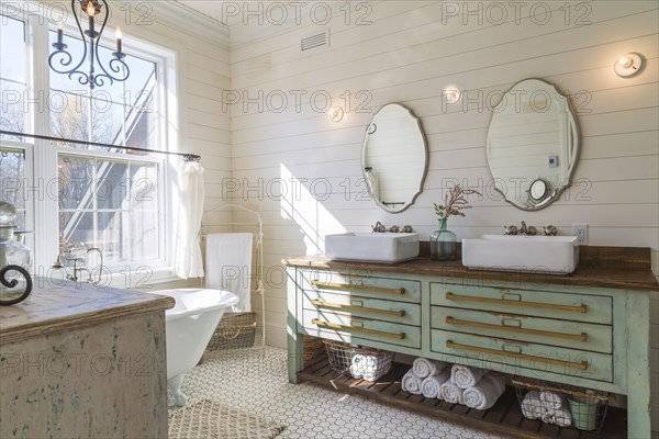 Green antique finish pine wood vanity with rustic wood plank countertop and white top-mounted his