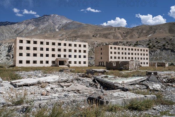 Abandoned, destroyed residential buildings, old Soviet apartment blocks in the ghost town,