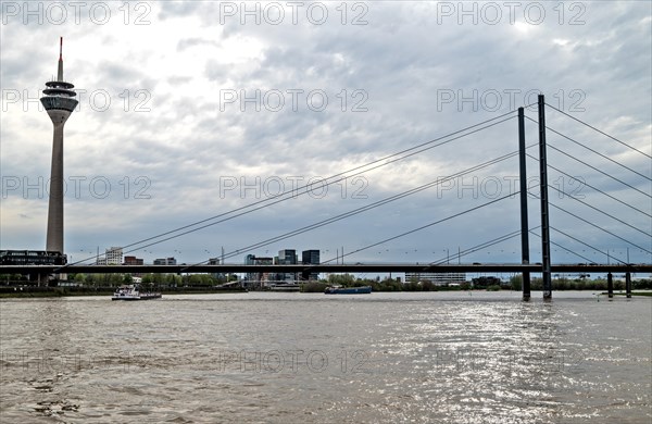 Rheinpromenade, view of Rheinkniebruecke, and Rheinturm Duesseldorf, North Rhine-Westphalia,