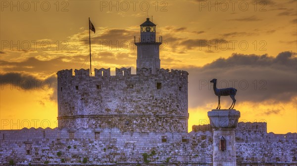 The ancient structure of a castle with a lighthouse during a picturesque sunrise, sunrise, dawn,